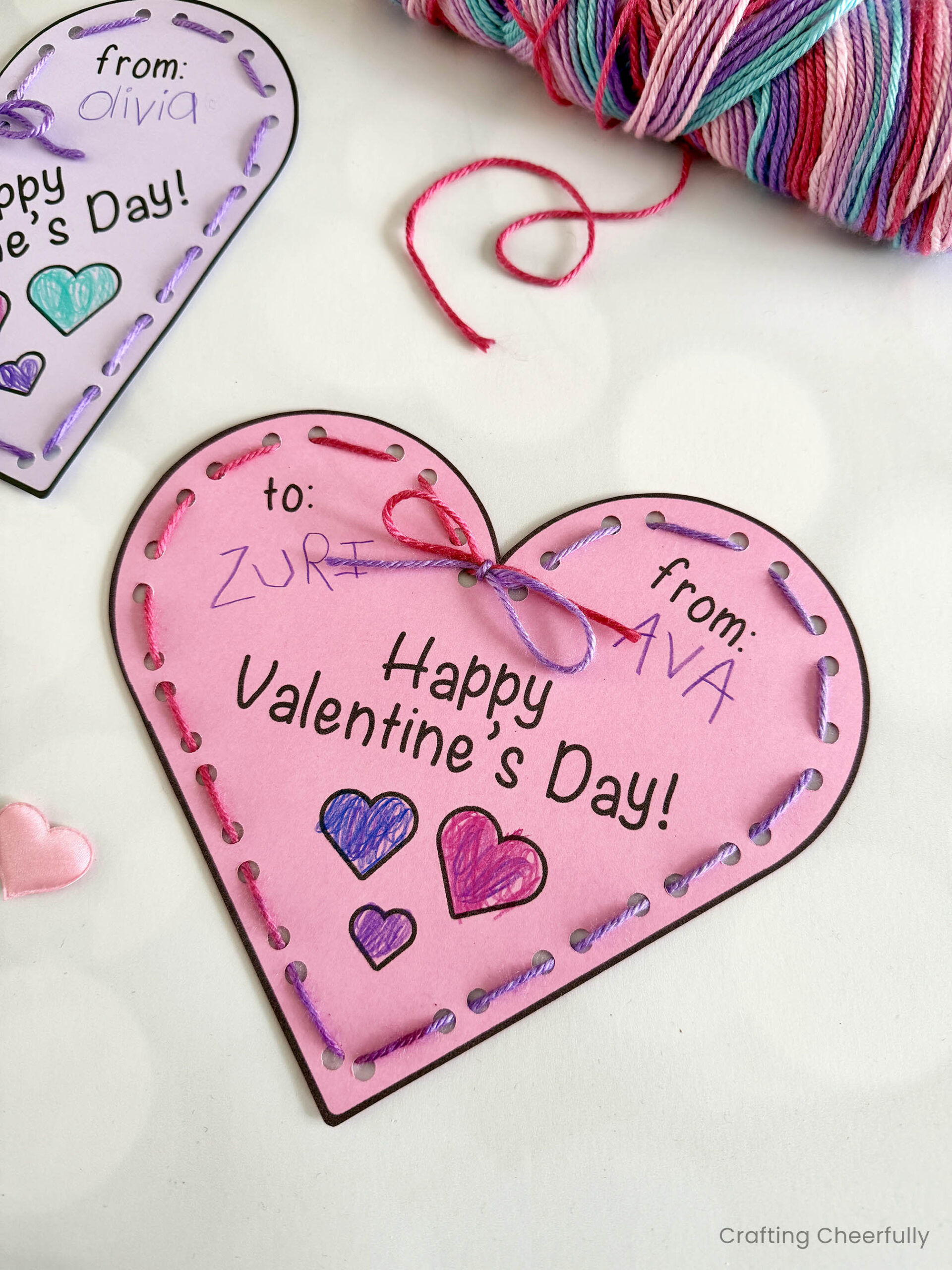Lacing heart valentine reads Happy Valentine's Day and is colored in with colored pencils.