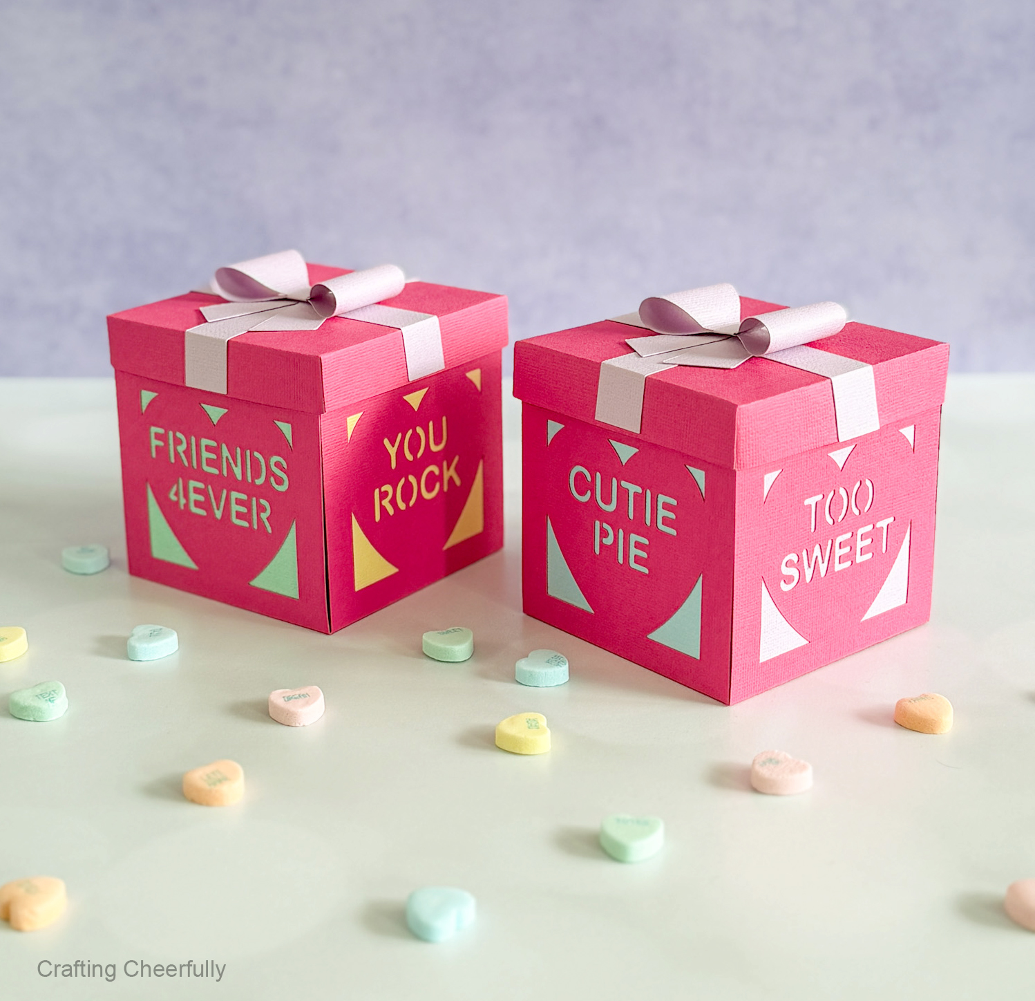 Two Valentine’s Day explosion boxes; each side features a different conversation heart with phrases like Friends Forever and Two Sweet.