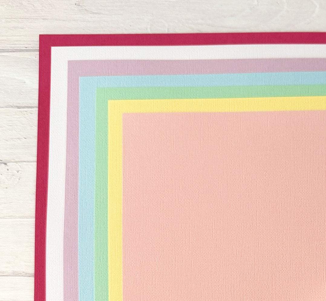 A group of colorful paper peices of paper on a white surface. 