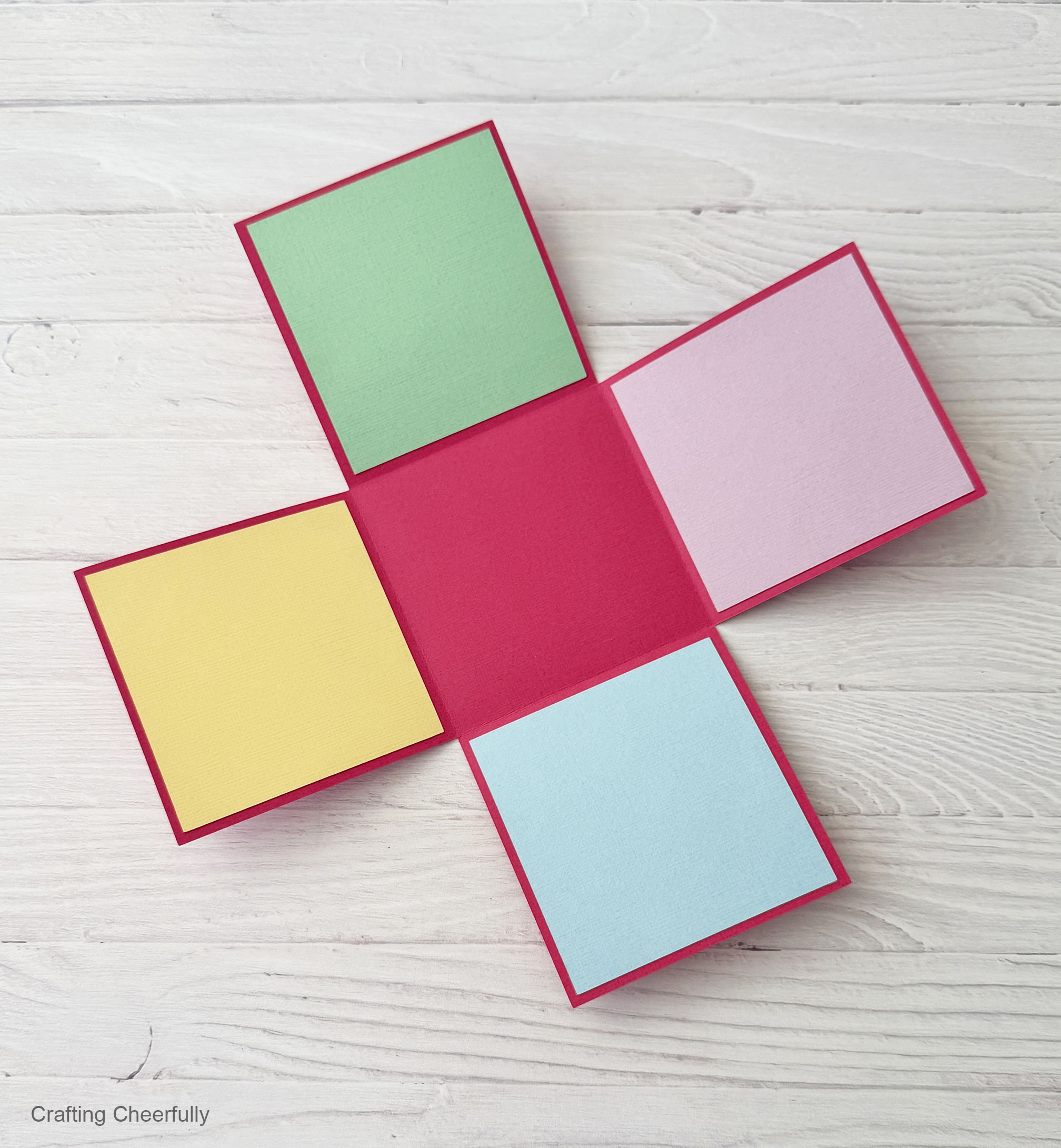 The colorful squares of paper are applied to each side of the explosion box.