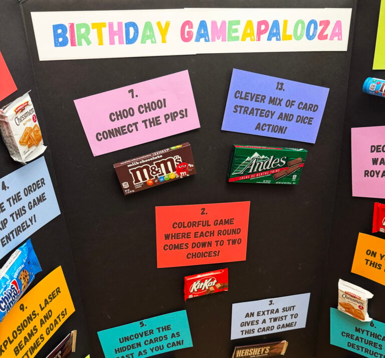 Birthday Gameaplooza tri-fold board is decorated with candy and colorful paper signs.