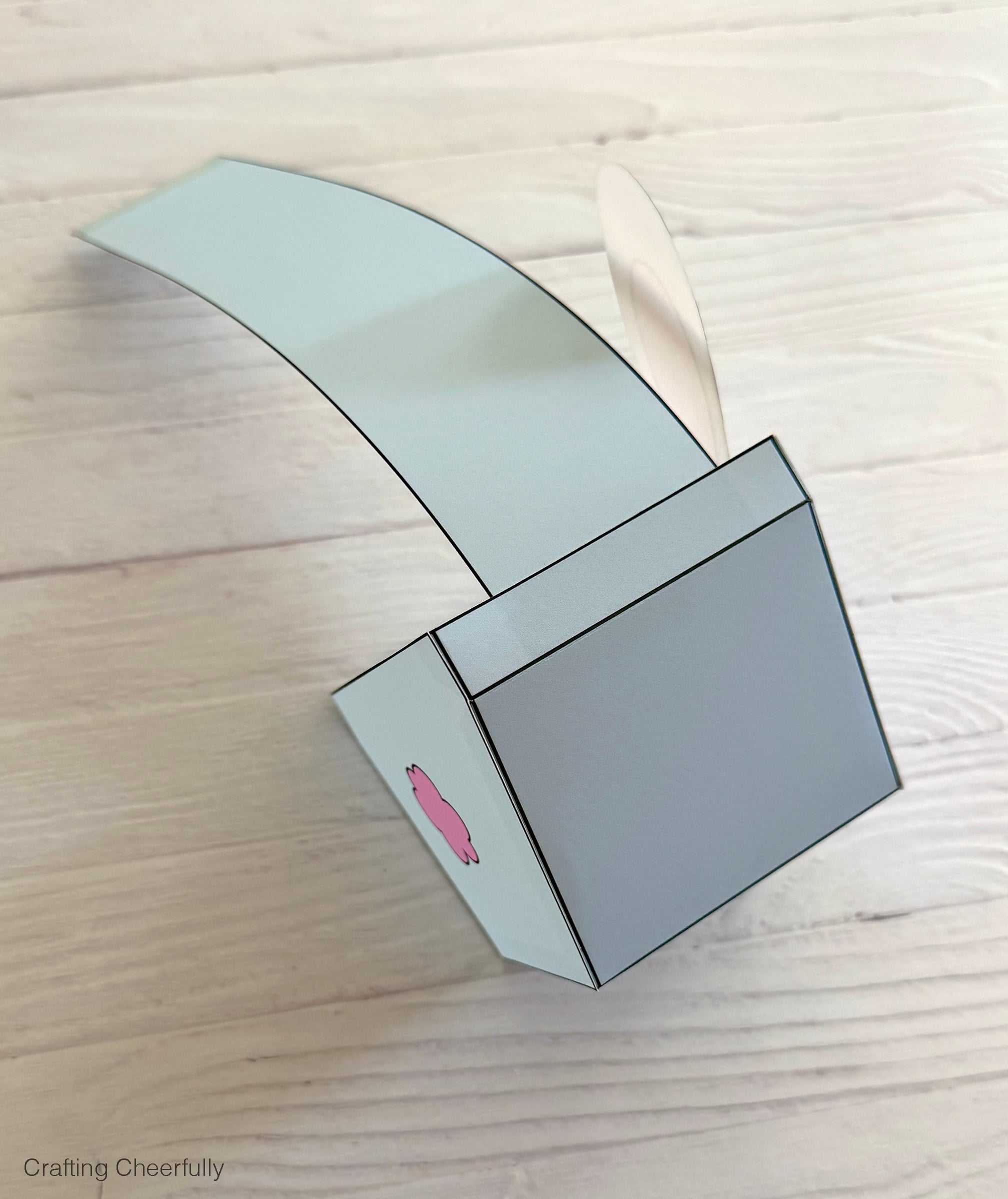 One end of the handle is attached to the box.