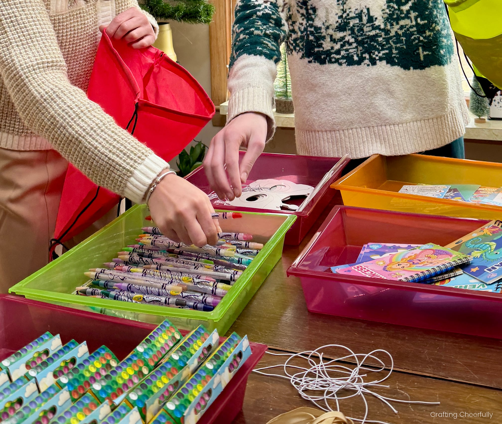 People assembling kits by adding supplies into cinch sacks.