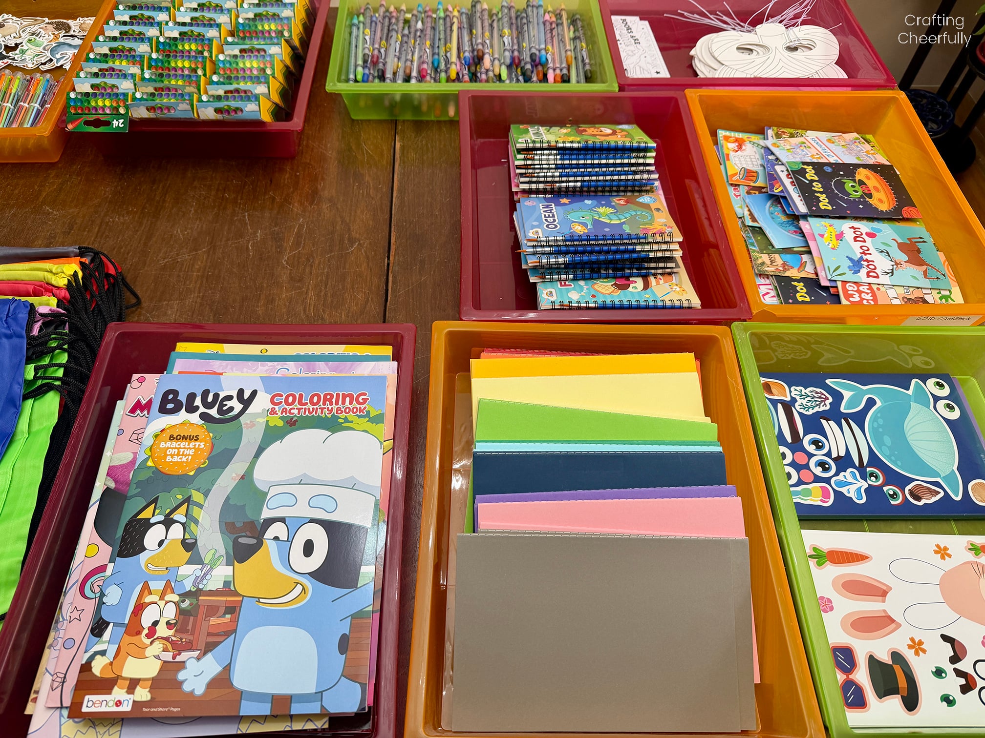 Table with supplies set up in colorful trays.