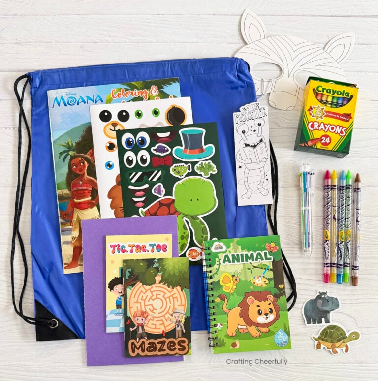 Coloring Kit spread out on a white table showing all the coloring books, crayons and more that are included in hte kits.