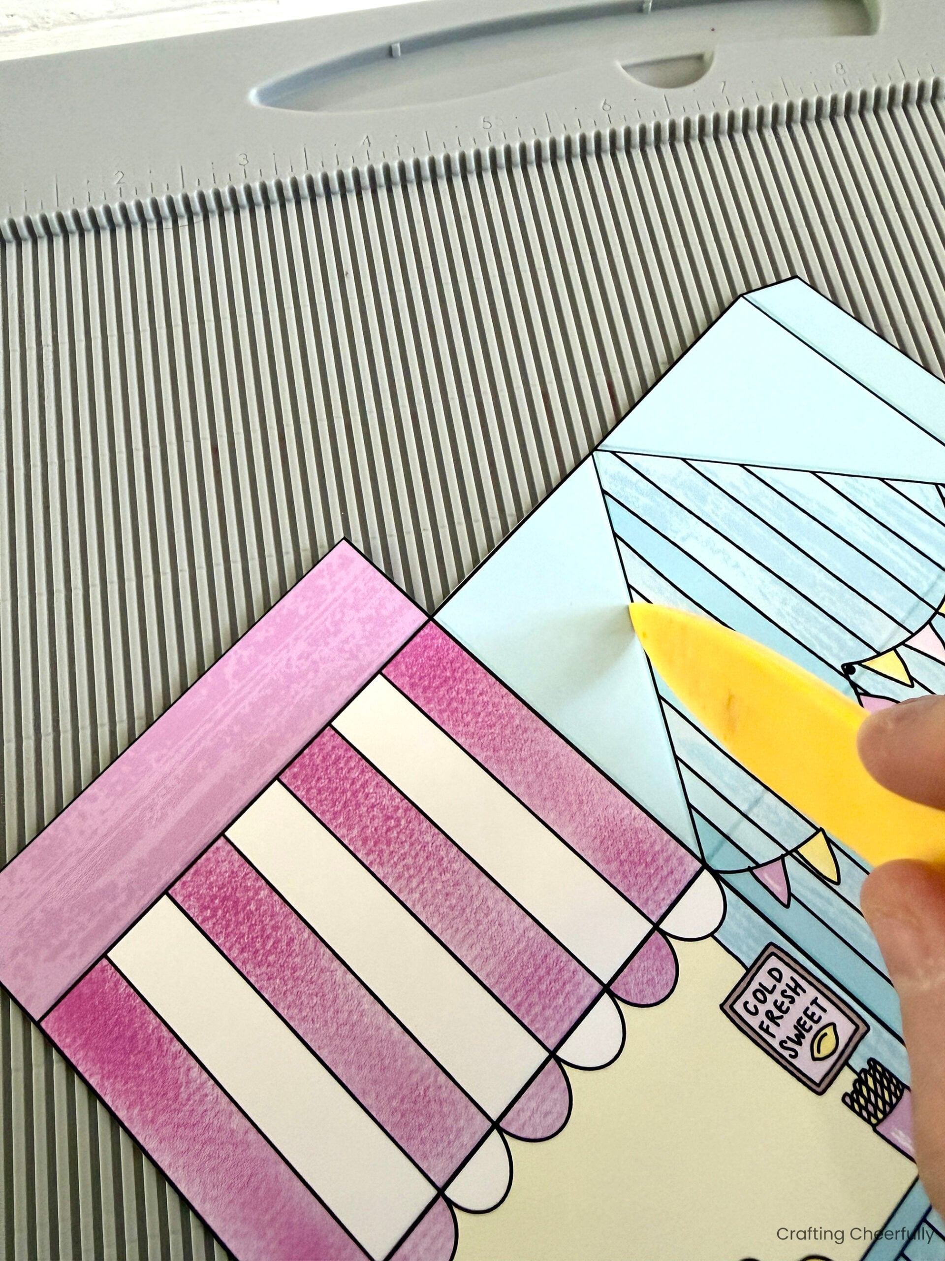 Paper treat boxes are scored using a scoring board and stylus.