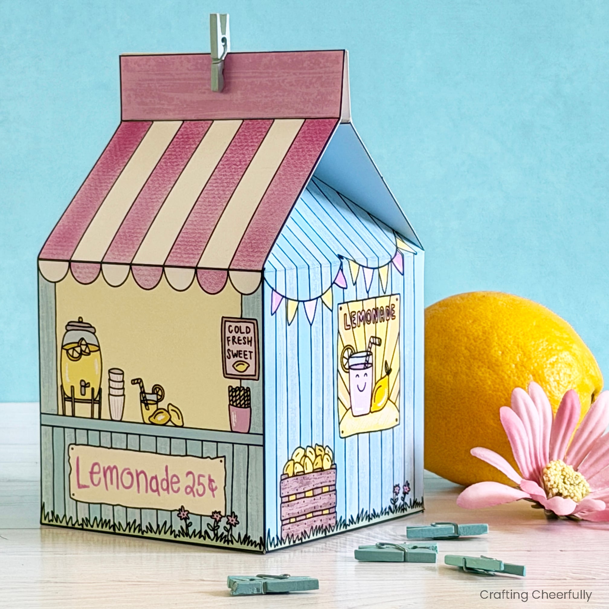 Lemonade Stand treat box sits next to a lemon.