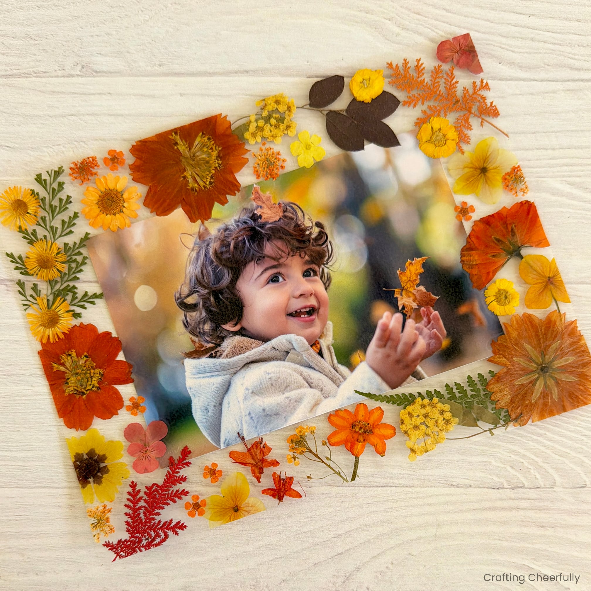 The cut out photo frame lays on a wood surface.