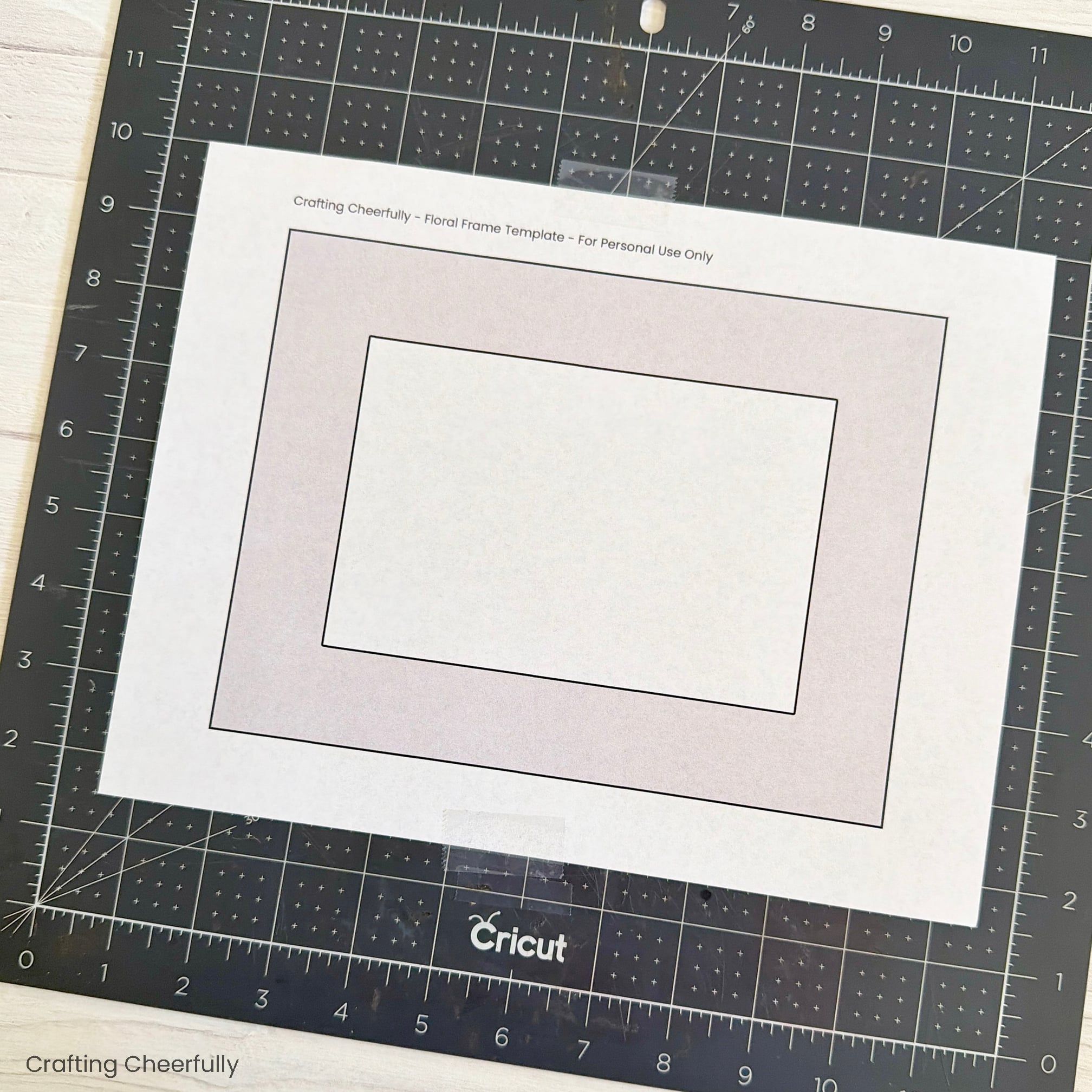The template is taped to a black cutting board.