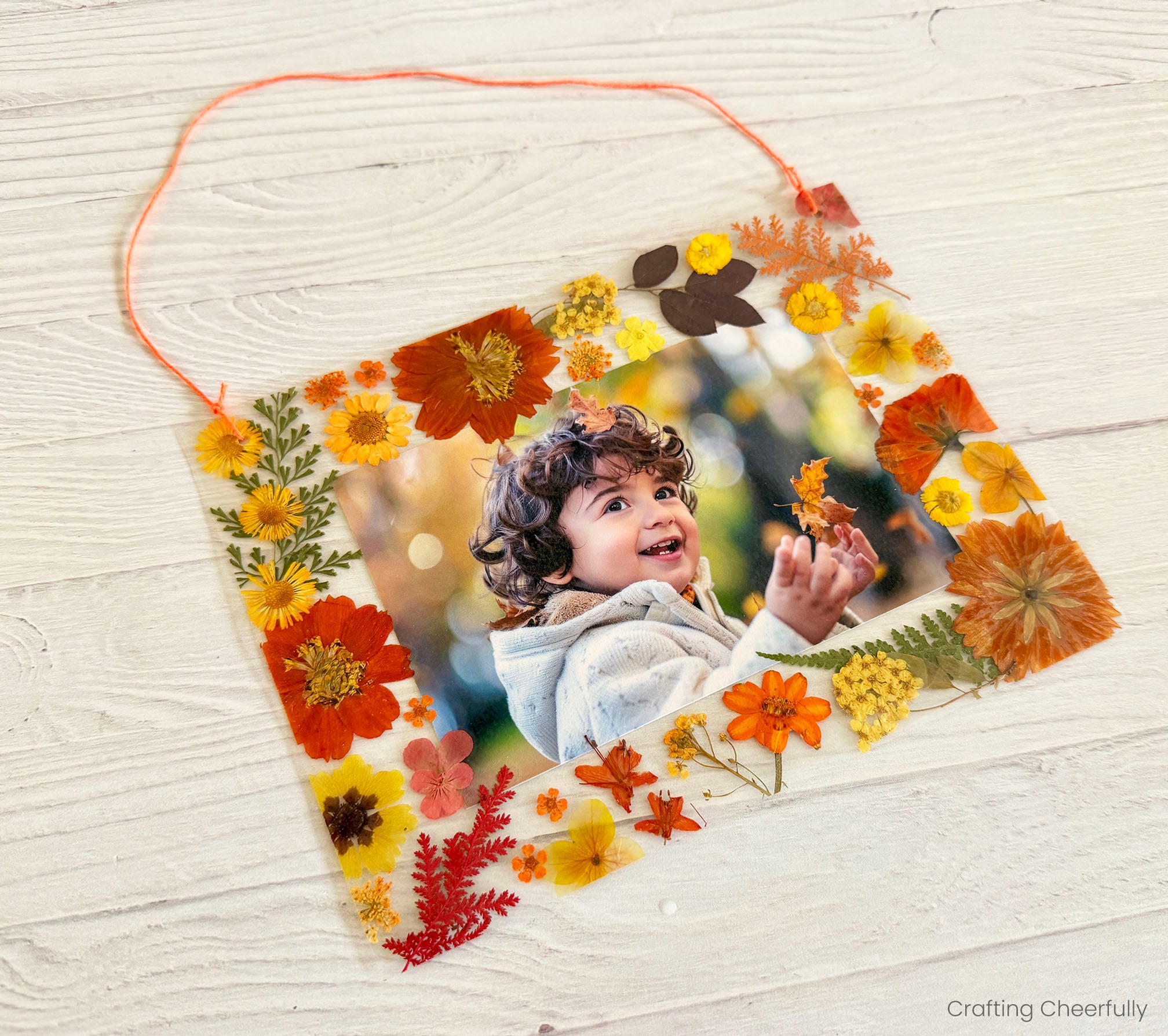 Pressed leaf frame has yarn handle.