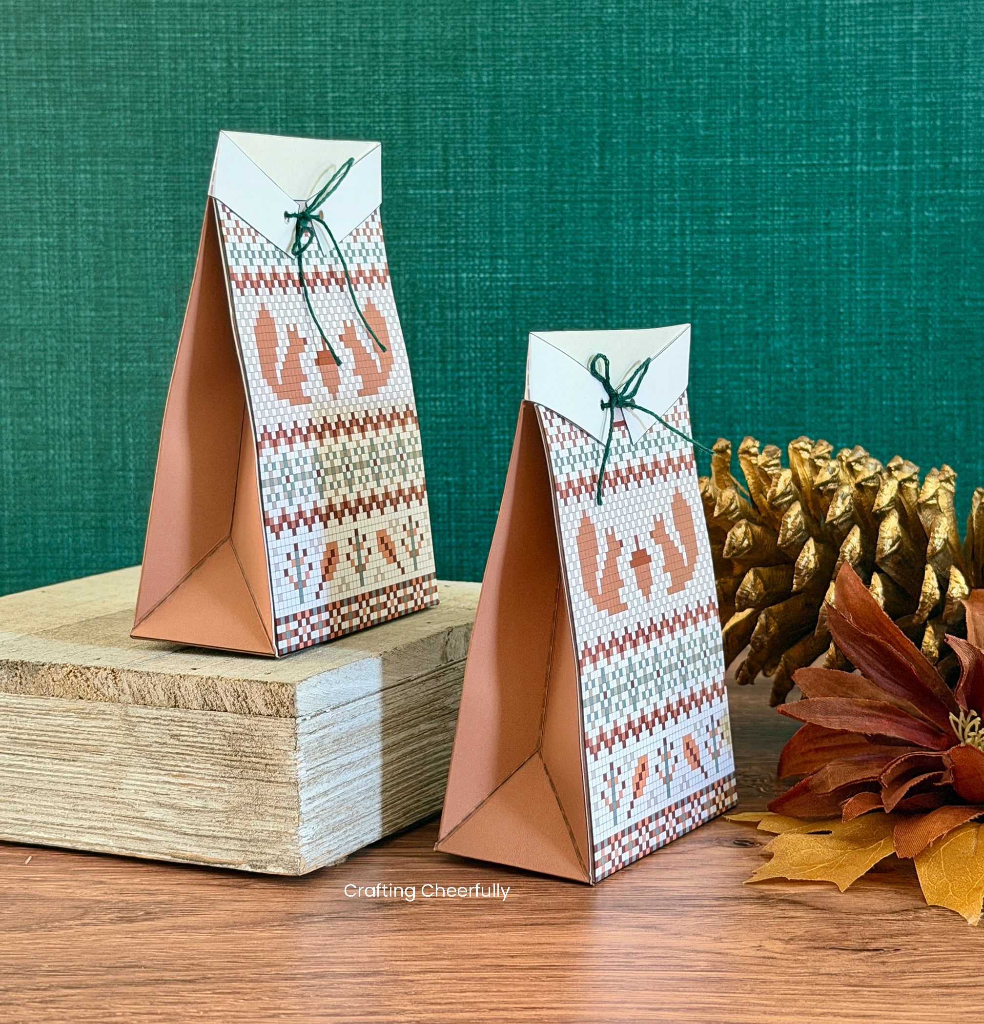 Two sweater treat boxes are set on a table and viewable from the side.