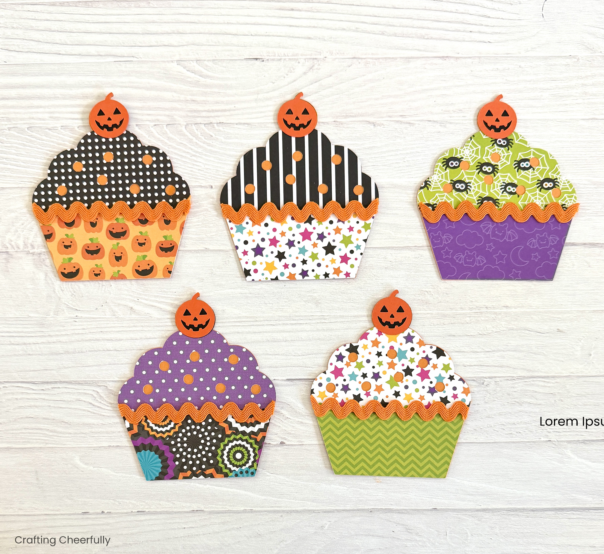 Halloween cupcakes made with colorful and patterned paper.