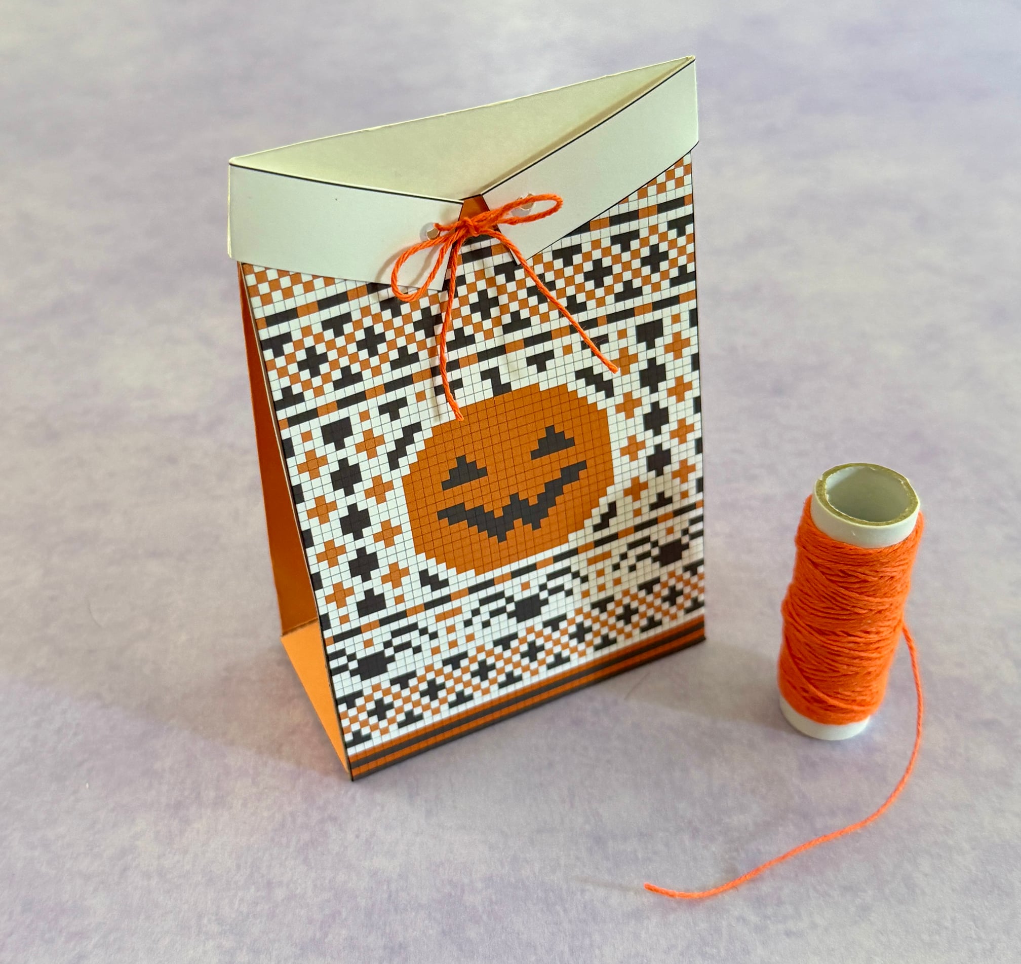Sweater treat box is tied closed with orange Baker's twine.