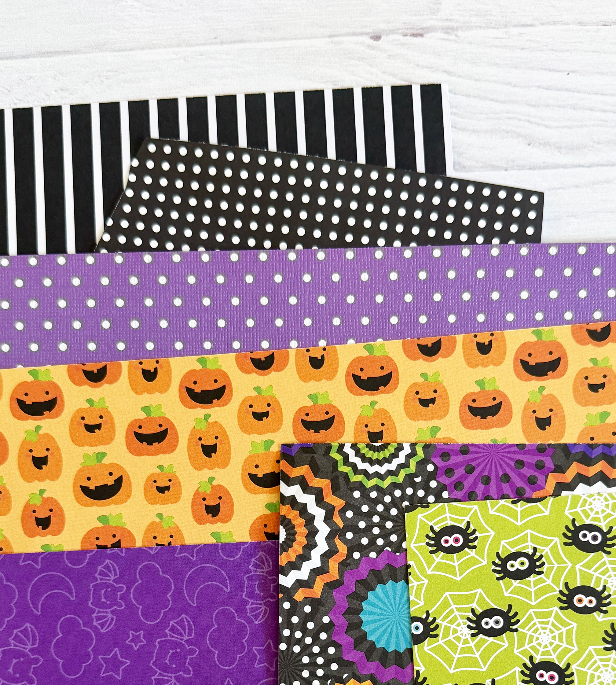 Halloween scrapbook paper and stripe and polkadot papers.